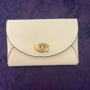 Authentic Coach turn-lock card case.